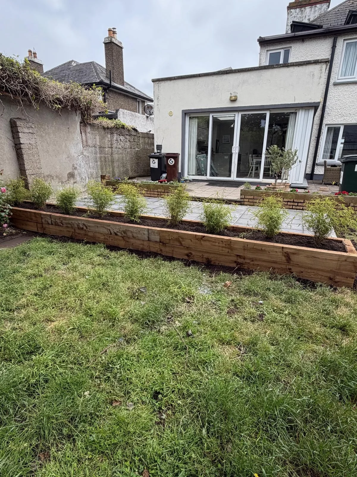 Completed paved patio with planted raised timber bed